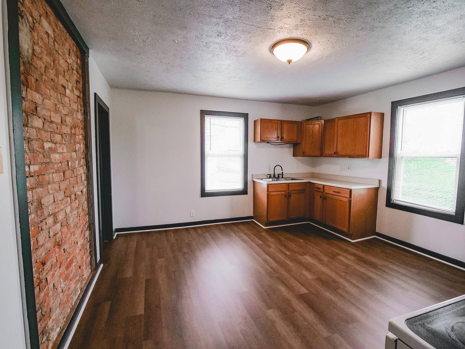 Kitchen with exposed brick at Gateway’s 3430 Cardiff Avenue listing