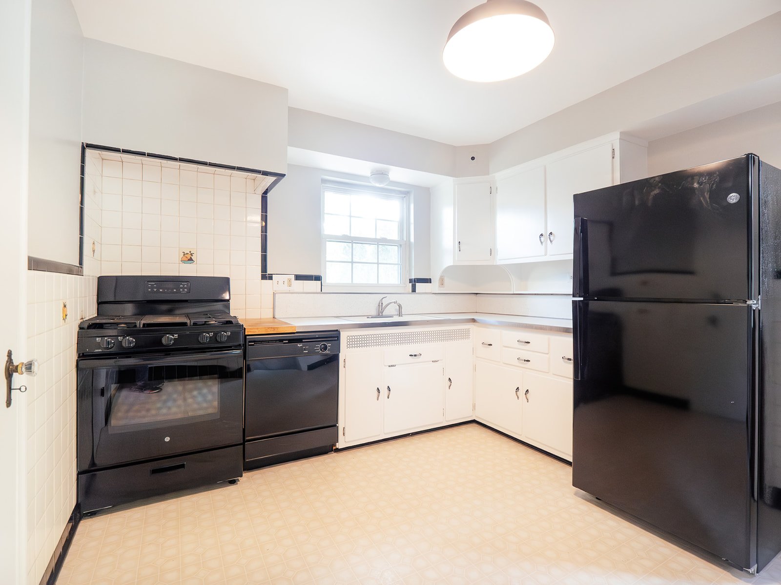 Classic kitchen with white cabinets and black appliances