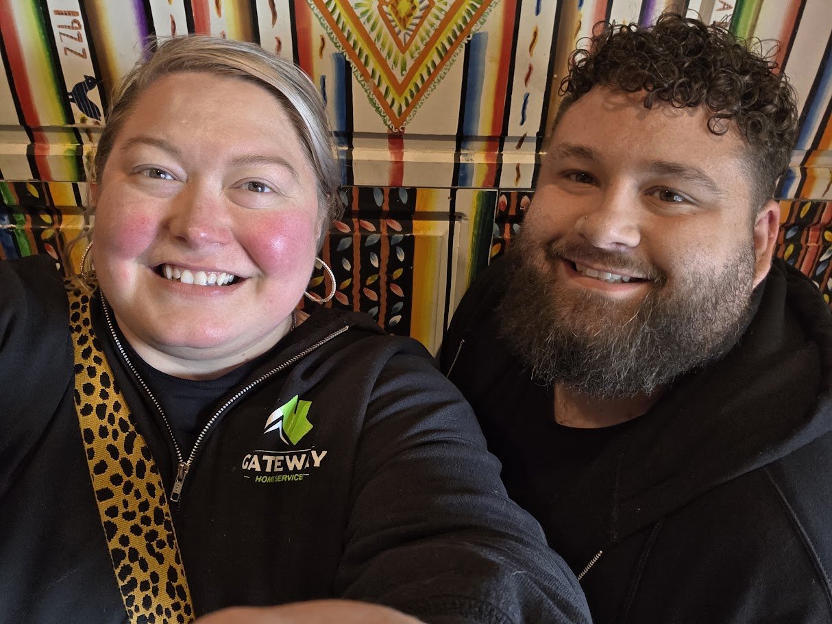 Two people smiling together in Gateway apparel