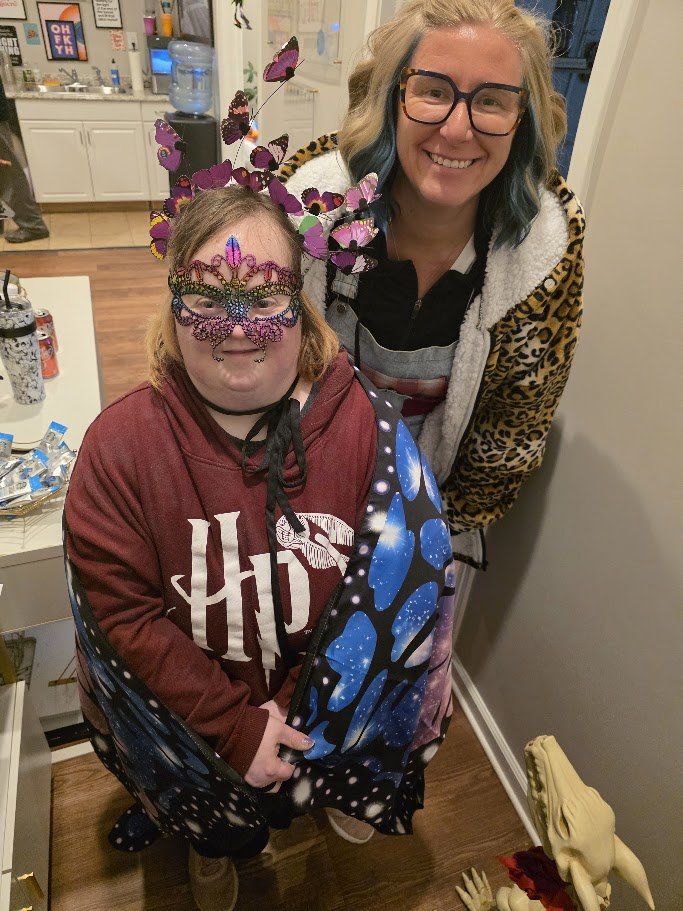 Two women in colorful Halloween costumes