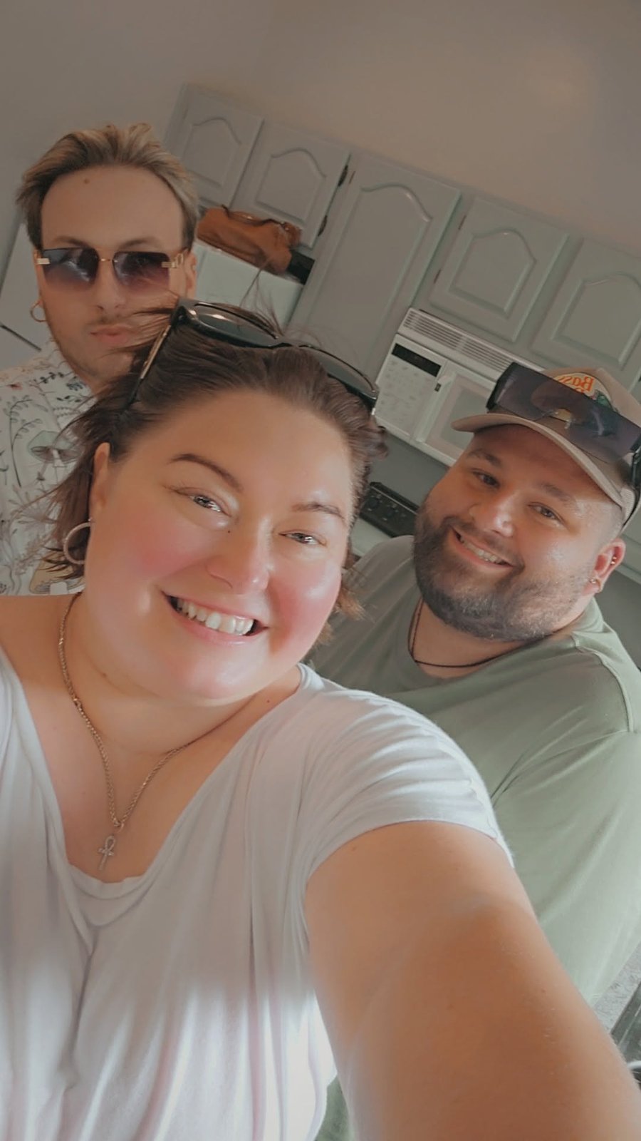 Three people smiling in an office selfie