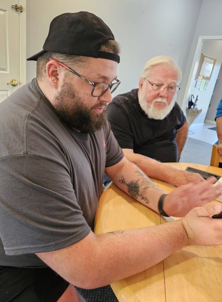 Two men working together at a table