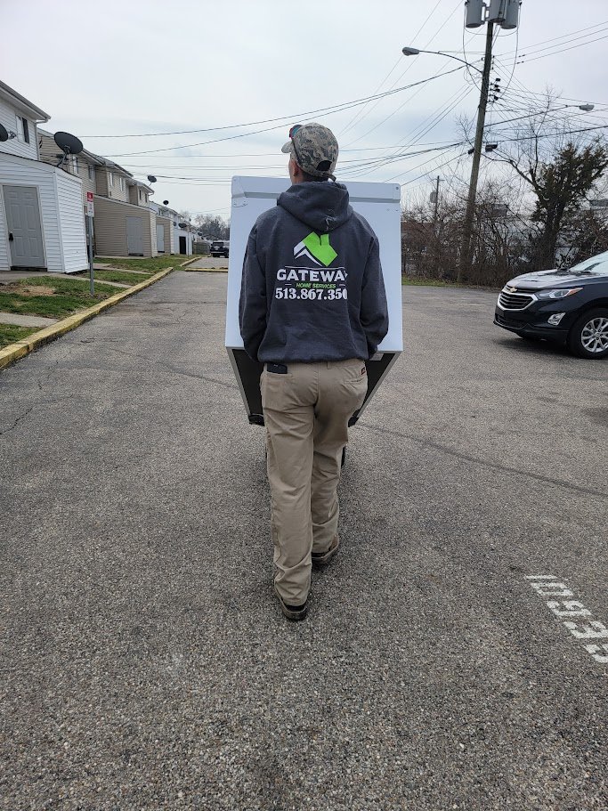 A person wearing a Gateway hoodie walking outdoors