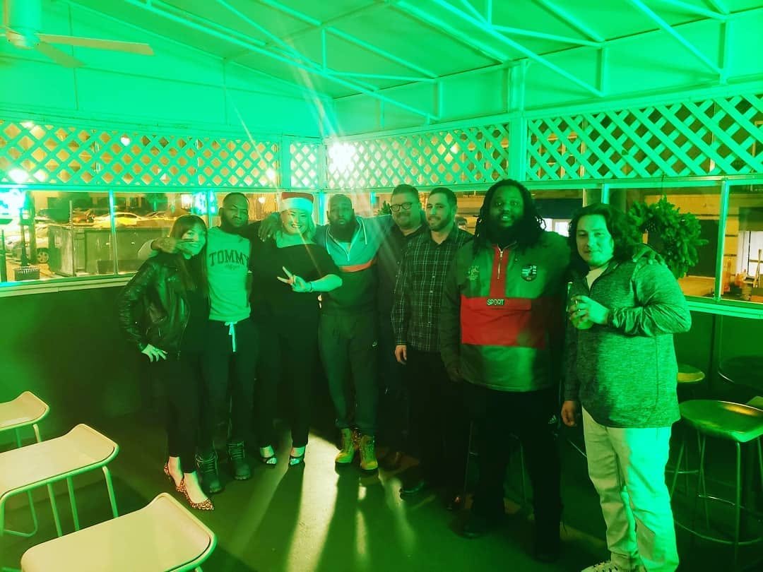 A group gathered together under green event lighting
